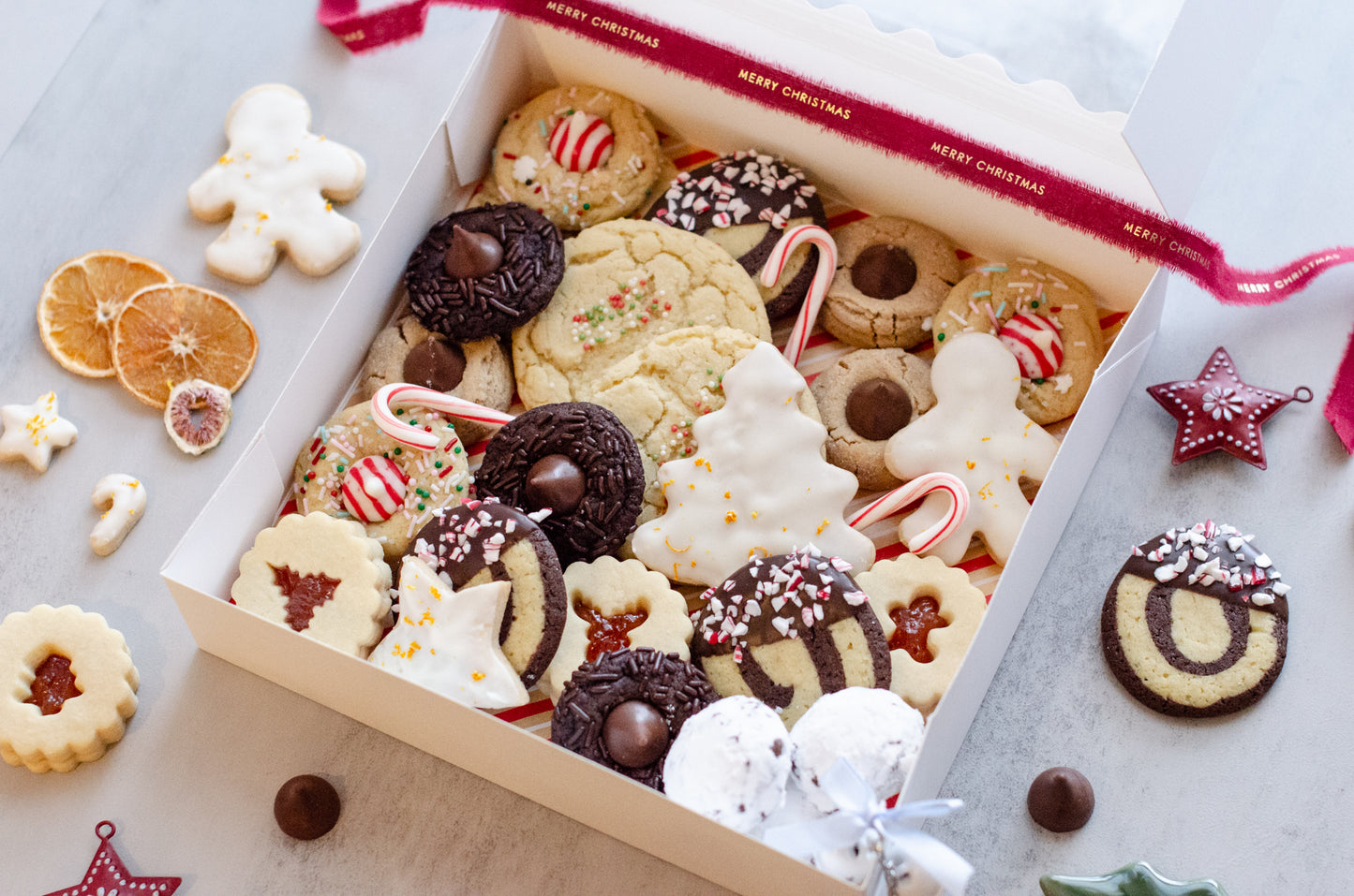 A 24-count holiday cookie box featuring a festive mix of seasonal flavors. Freshly baked in Darien, WI for holiday gifting, parties, and family celebrations. Pickup and delivery available.